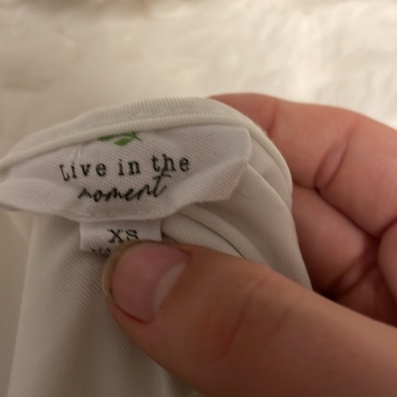 This is a great top the material is silky is a nice white almost never worn! - Picture 2 of 4